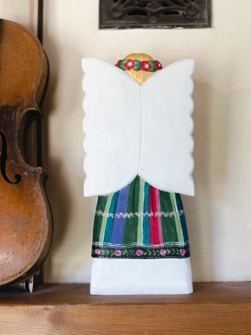 anioł rzeźbiony w łowickim pasiaku stojący tyłem