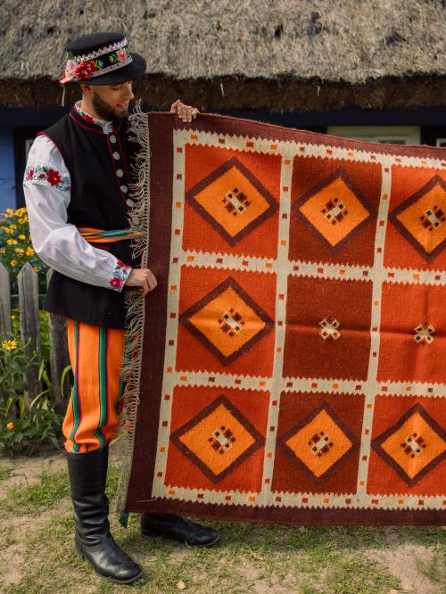kilim trzymany przez łowiczaka