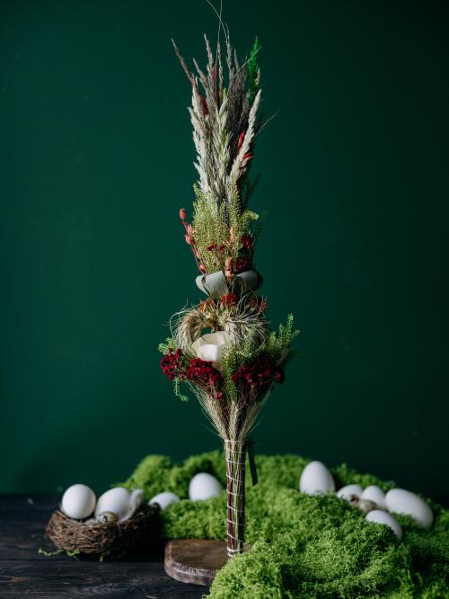 Palma z suszonych składników na tle zielonej ściany.